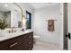 Elegant bathroom featuring custom vanity, stylish mirror, and tiled walk-in shower at 5290 Nassau E Cir, Cherry Hills Village, CO 80113