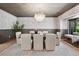 Formal dining room with large table, statement chandelier, and stylish wall coverings at 5290 Nassau E Cir, Cherry Hills Village, CO 80113