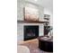 Stone fireplace with dark mantel and black insert and custom build-in shelving at 5290 Nassau E Cir, Cherry Hills Village, CO 80113
