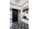 Modern foyer with black-and-white tile flooring, sleek console table, and stylish wall decor at 5290 Nassau E Cir, Cherry Hills Village, CO 80113
