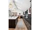 Modern kitchen features a central island, a breakfast nook, and stainless steel appliances under a high ceiling with skylights at 5290 Nassau E Cir, Cherry Hills Village, CO 80113