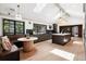 Bright modern kitchen with island, breakfast nook and dark cabinets, illuminated by natural light from large windows and skylights at 5290 Nassau E Cir, Cherry Hills Village, CO 80113