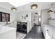 Well-lit laundry room with modern appliances, custom cabinets, and a utility sink, offering both style and practicality at 5290 Nassau E Cir, Cherry Hills Village, CO 80113