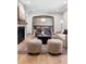 Open-concept living room with stone fireplace, plush seating, and seamless flow to the dining area at 5290 Nassau E Cir, Cherry Hills Village, CO 80113