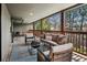 Spacious covered porch features comfortable seating, a stylish fire pit, and scenic views of the surrounding greenery and outdoor bar area at 5290 Nassau E Cir, Cherry Hills Village, CO 80113