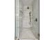 Luxurious shower featuring marble tiling, glass enclosure, and dual shower heads at 5290 Nassau E Cir, Cherry Hills Village, CO 80113
