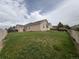 A grassy backyard with view of the rear elevation of a home at 11304 Niagara St, Thornton, CO 80233