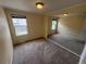 Neutral bedroom with wall mirror, carpeted floors, and natural light from the windows at 11304 Niagara St, Thornton, CO 80233
