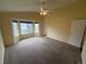 Inviting bedroom featuring carpet, a ceiling fan, and bay windows for ample natural light at 11304 Niagara St, Thornton, CO 80233