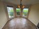 Cozy breakfast nook with three large windows and a stylish chandelier at 11304 Niagara St, Thornton, CO 80233