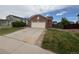 Traditional brick home with attached garage, manicured lawn, and inviting curb appeal at 11304 Niagara St, Thornton, CO 80233