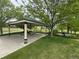 A park pavilion with picnic tables under mature shade trees at 11304 Niagara St, Thornton, CO 80233