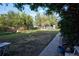 Large grassy backyard with mature trees and a walkway at 1620 Colorado Blvd # 6, Denver, CO 80220