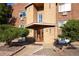 Building's front entrance with brick facade and shrubs at 1620 Colorado Blvd # 6, Denver, CO 80220