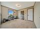 Bedroom featuring neutral walls, plush carpet, natural light from the window, and a built in work-from-home space at 4255 S County Road 185, Byers, CO 80103