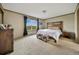 Bedroom featuring neutral walls, plush carpet, natural light from the large window, and traditional furniture and decor at 4255 S County Road 185, Byers, CO 80103