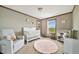Bright Bedroom with scenic window, plush rug, rocking chair and modern decor at 4255 S County Road 185, Byers, CO 80103