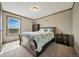Comfortable bedroom with large window, cozy carpet, traditional furniture and decor at 4255 S County Road 185, Byers, CO 80103