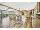 Open concept living space featuring kitchen island and a dining area with views of the backyard at 4255 S County Road 185, Byers, CO 80103