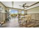 Cozy dining area with backyard access, plenty of sunlight, wood-paneled walls and modern furniture at 4255 S County Road 185, Byers, CO 80103