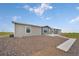 Newly renovated home featuring a modern exterior with gray siding and a well-maintained gravel yard at 4255 S County Road 185, Byers, CO 80103