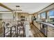 Bright kitchen with island, stainless steel appliances, light wood cabinets, and cow-print bar stools at 4255 S County Road 185, Byers, CO 80103