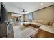 Bright living room with view of the kitchen, comfortable sectional sofa, and modern entertainment center at 4255 S County Road 185, Byers, CO 80103