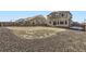 Expansive backyard with a mix of grass and gravel, enclosed by a wooden fence for privacy at 296 N Newcastle Way, Aurora, CO 80018