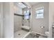 A full bathroom features a glass enclosed walk-in shower with a built-in bench at 296 N Newcastle Way, Aurora, CO 80018