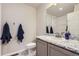 Bathroom features modern fixtures, gray vanity with marble countertop, and a tiled shower at 296 N Newcastle Way, Aurora, CO 80018
