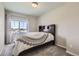 Neutral bedroom with a large window, gray carpet, and dark wood headboard; serene and well-lit at 296 N Newcastle Way, Aurora, CO 80018