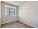 A bedroom with an exterior view featuring hardwood floors, base trim and neutral paint throughout at 296 N Newcastle Way, Aurora, CO 80018