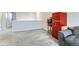 Bonus room with retro red refrigerator and gray couch at 296 N Newcastle Way, Aurora, CO 80018