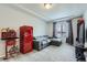 Bonus room with gray couch, vintage popcorn maker and red retro refrigerator at 296 N Newcastle Way, Aurora, CO 80018