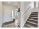 Bright entryway with hardwood floors, a staircase, and a view into the living area at 296 N Newcastle Way, Aurora, CO 80018