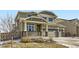 Charming two-story home with a three-car garage, stone accents, and inviting front porch at 296 N Newcastle Way, Aurora, CO 80018