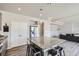 A kitchen features an island with granite countertop and seating, stainless steel appliances, and gray cabinets at 296 N Newcastle Way, Aurora, CO 80018