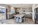 Modern kitchen featuring an island with seating, gray cabinets, and stainless steel appliances at 296 N Newcastle Way, Aurora, CO 80018