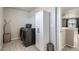 Laundry room features modern machines, ample storage, and a clean, functional space at 296 N Newcastle Way, Aurora, CO 80018