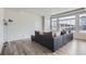 Bright living room featuring hardwood floors, a modern light and a large sectional sofa at 296 N Newcastle Way, Aurora, CO 80018