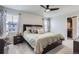 A main bedroom features two windows, carpet floors, and bedside tables at 296 N Newcastle Way, Aurora, CO 80018