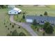 Aerial view of property with barns, landscaping, house, and a long driveway at 3596 Longs Peak Cir, Parker, CO 80138