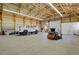 Expansive barn interior featuring a vehicle, equipment, and ample storage space at 3596 Longs Peak Cir, Parker, CO 80138