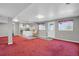 Finished basement with a kitchenette, carpet, tile flooring, and ample space at 3596 Longs Peak Cir, Parker, CO 80138