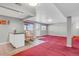 Finished basement with kitchenette, rocking chair, and an exit door at 3596 Longs Peak Cir, Parker, CO 80138