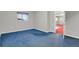 Finished basement with blue carpet and natural light at 3596 Longs Peak Cir, Parker, CO 80138