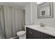 Bathroom featuring a dark vanity with a white countertop and a shower with curtain at 3596 Longs Peak Cir, Parker, CO 80138