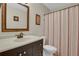 Traditional bathroom features a vanity, toilet, and framed mirror at 3596 Longs Peak Cir, Parker, CO 80138