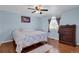 Comfortable bedroom with hardwood floors, ceiling fan, and a dresser at 3596 Longs Peak Cir, Parker, CO 80138