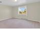 Bright bedroom with neutral walls, carpet floors, and a window providing natural light at 3596 Longs Peak Cir, Parker, CO 80138